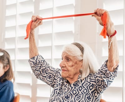 Senior participating in an activity with exercise bands