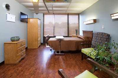 A cozy resident room with bed and furnishings