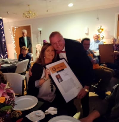Celebration event with residents and staff in a dining area