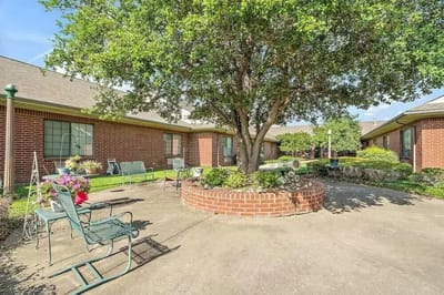 Outdoor patio area with seating and landscaping