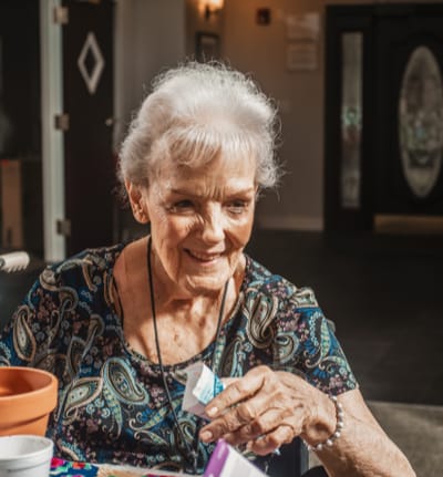 Resident engaging in an activity with a joyful expression