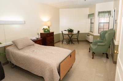A private resident room with bed and furnishings