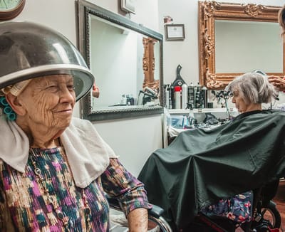 Residents enjoying a salon haircut and styling.