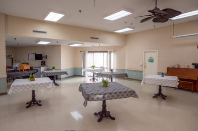 Bright and spacious common area with tables and chairs