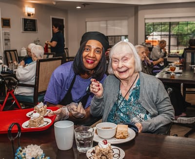 Residents enjoying dessert in a dining area