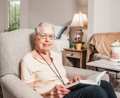 Resident reading in a cozy living space