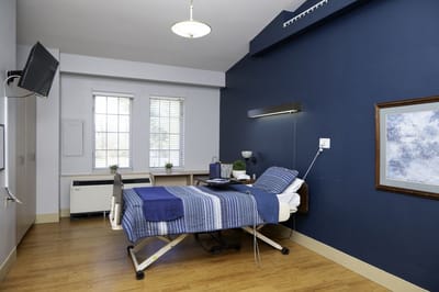 Comfortable resident room with a hospital bed and window