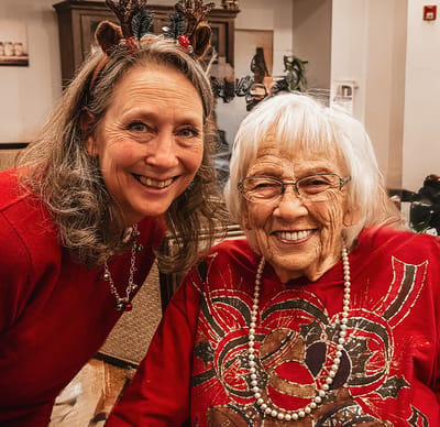 Staff member and resident celebrating with festive attire