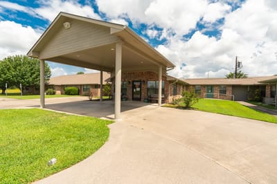 Front entrance of the assisted living facility under a shaded area