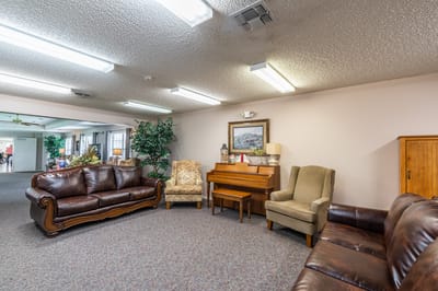 Cozy interior common area with seating and piano