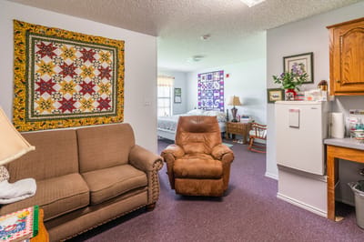 Cozy commons area with a couch and kitchenette