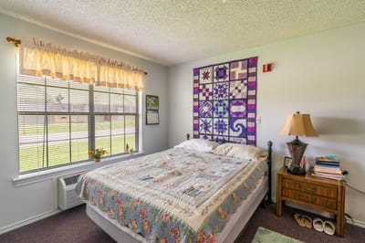Cozy private resident room with colorful quilt
