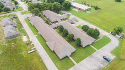 Aerial view of a senior living facility complex with buildings and green spaces