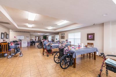 Residents socializing in a common area with wheelchairs
