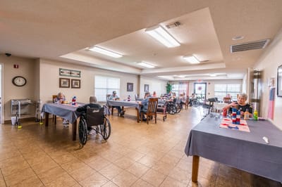 Residents engaged in activities in a spacious common area