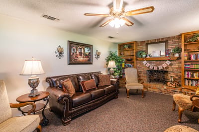 Cozy common area with seating and bookshelf