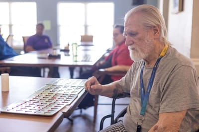 Resident playing bingo in an activity room
