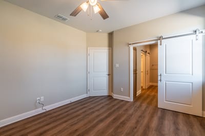 Bright and spacious resident room with a ceiling fan