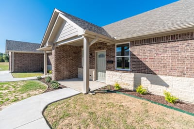 Exterior view of a senior living facility with garden
