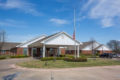 Exterior view of Country Home Estates building with flagpole