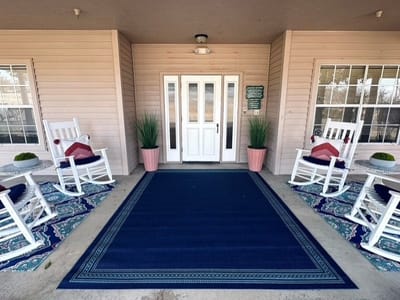 Welcoming entrance with rocking chairs and blue rug