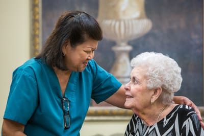 A caregiver interacting with a resident in a warm setting