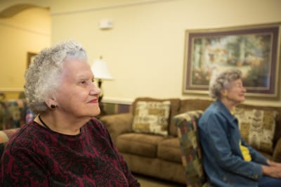Two older women sitting comfortably in a lounge area