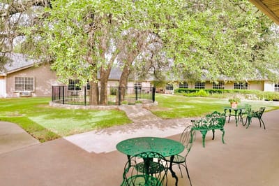 Outdoor space with tables and a garden area