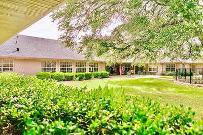 Exterior view of the facility surrounded by greenery