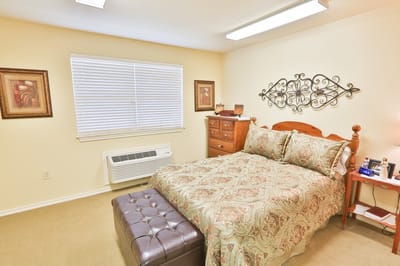 Cozy private resident room with a bed and dresser