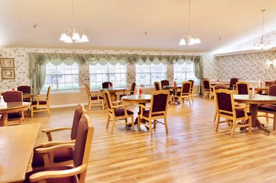 Bright dining room with tables and chairs set for meals