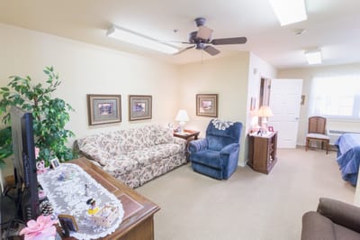 Cozy resident room with floral sofa and chairs