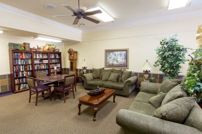 Cozy common area with seating and a bookshelf