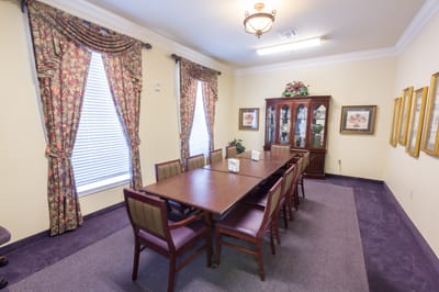 Well-furnished common area with a large table and chairs