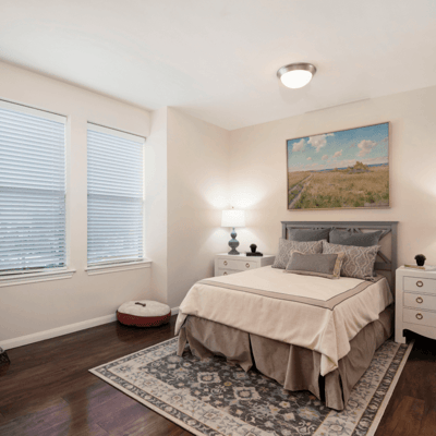 Cozy private bedroom with natural light and artwork