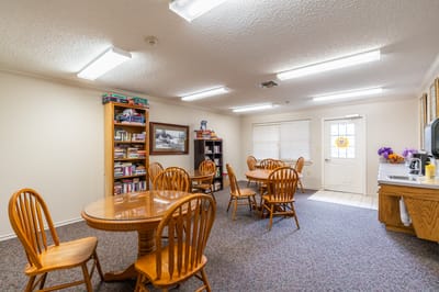 Bright common area with tables and bookshelves