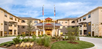 Exterior view of Village on the Park Plano with flags