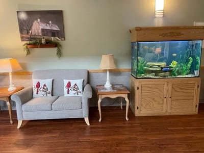 Cozy common area with seating and aquarium