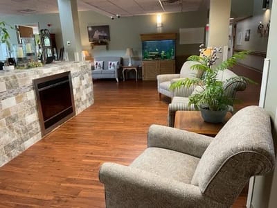 Common area with seating and aquarium in a senior living facility