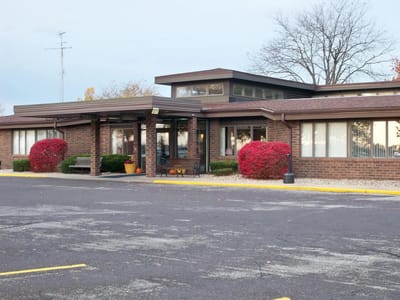 Exterior view of The Elms facility with landscaping