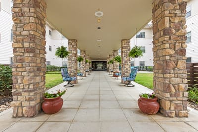 Covered walkway with seating and greenery