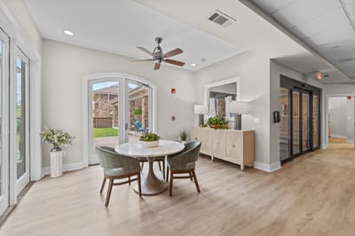 Bright common area with a round table and chairs