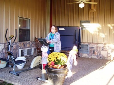 Resident exercising outdoors with equipment