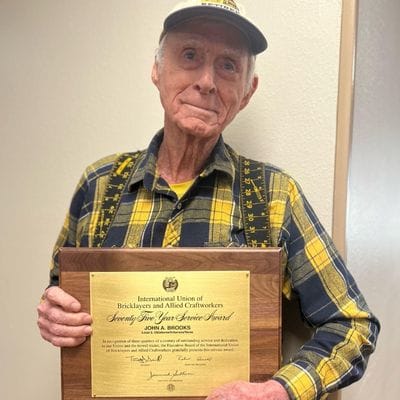 Elderly man receiving a service award