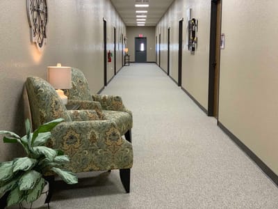 A quiet hallway with seating and decor