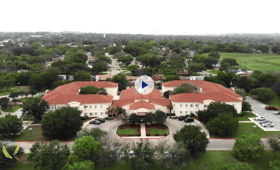 Aerial view of a senior living community with landscaped grounds