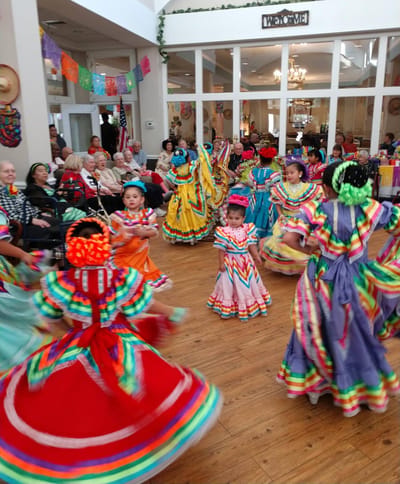 Residents enjoying a cultural dance performance in a common area