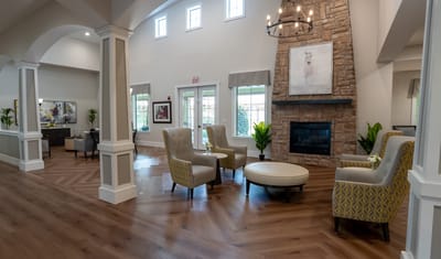 Bright interior common area with seating and a fireplace