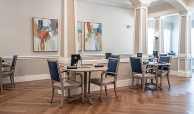Dining area with tables and colorful artwork