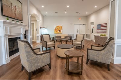 Bright common area with seating and a dog painting